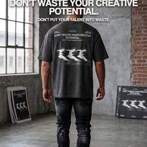 May include: A person wearing a dark gray t-shirt with the text "DON'T WASTE YOUR CREATIVE POTENTIAL." The shirt also features a graphic of three stylized birds. The person is wearing black jeans. The image includes additional text and graphics.