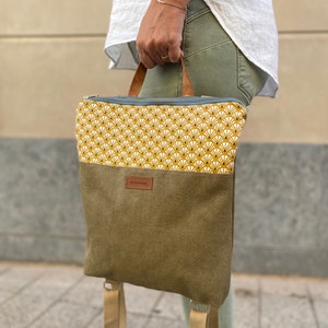mustard, white with green waxed canvas effect backpack details