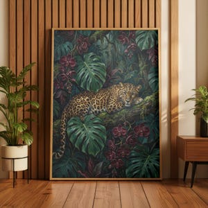May include: A framed art print showing a leopard resting on a branch, surrounded by dense tropical plants. The artwork uses greens, browns, and deep reds, with detailed leaves and flowers. The leopard's spotted coat is a key feature.