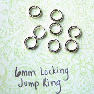 May include: Eight silver 6mm locking jump rings. The rings are open and have a smooth finish.