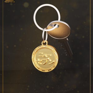 May include: A gold-colored keychain with a round pendant featuring Japanese characters. The keychain includes a key and a gold-colored key fob. The words "High-Quality" and "Presupported" are in the upper left corner.