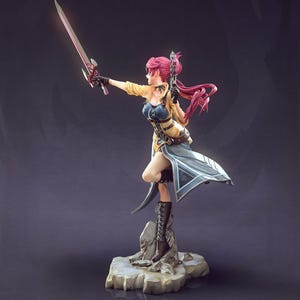 May include: A detailed figurine of a female warrior in a dynamic pose, holding a glowing sword. She wears a yellow jacket, blue bodice, and flowing skirt. Her long pink hair is swept back, and she stands on a rocky base. The figure is approximately 10 inches tall.