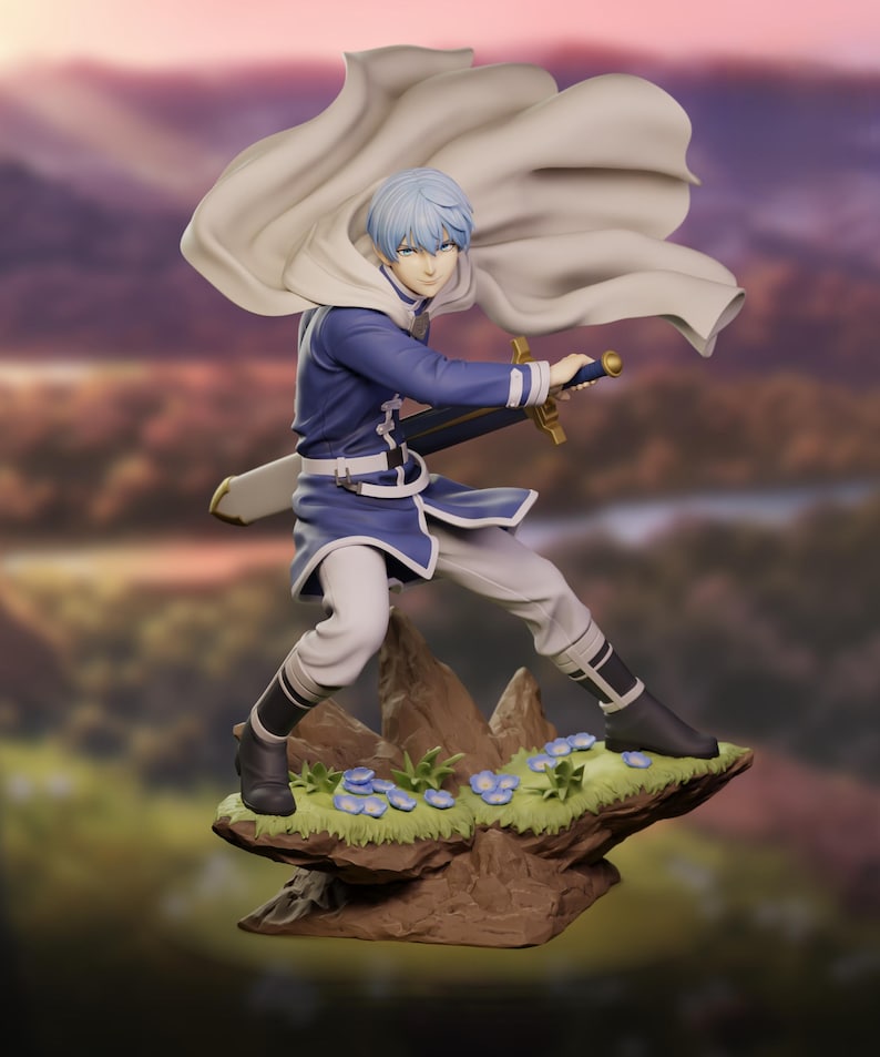 May include: A figurine of a character in a blue and white outfit, holding a sword. The figure has light blue hair and a white cape. It stands on a rocky base with small blue flowers and green grass. The background is a blurred landscape.