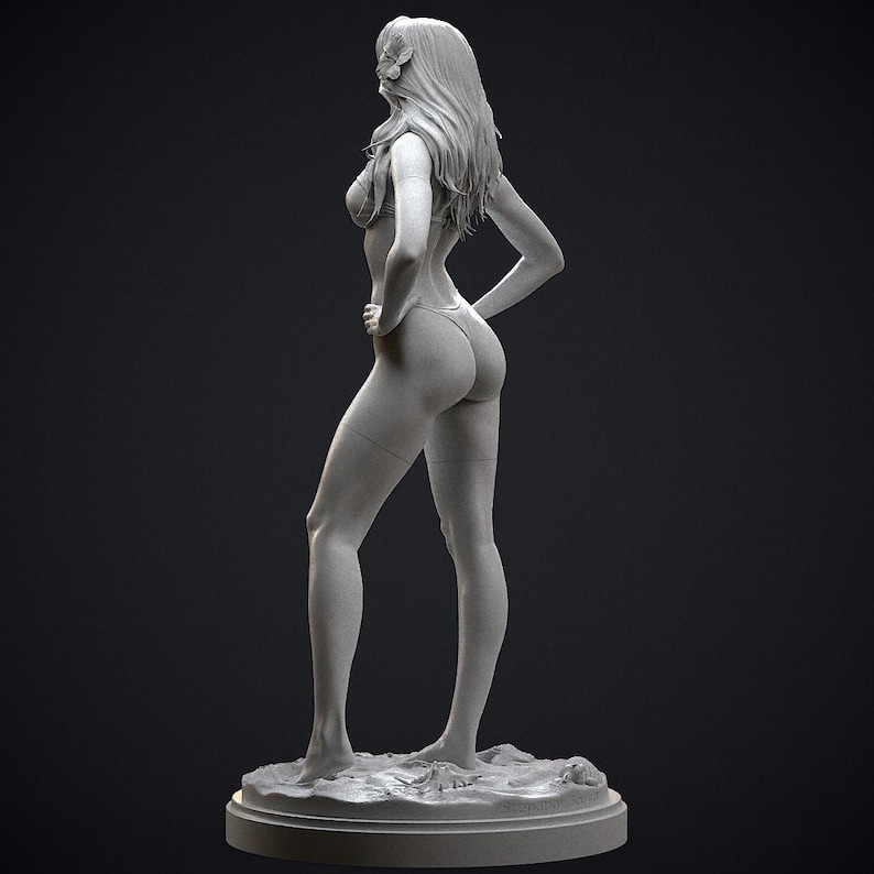 May include: A gray sculpture of a person in a swimsuit, standing with one hand on their hip. The figure has long hair and is posed on a circular base. The sculpture is detailed and appears to be made of a solid material.