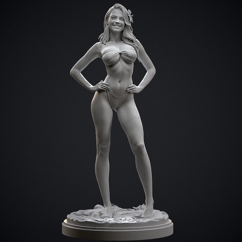 May include: A grayscale sculpture of a woman in a bikini, standing with hands on hips. The figure has long hair and a flower in her hair. The sculpture is on a round base with a textured surface, set against a dark background.