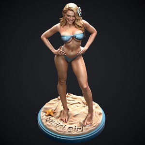 May include: A figurine of a woman in a blue bikini, standing on a sandy base with a starfish. The base has the words "bikini girl" written on it. The woman has blonde hair and is smiling.