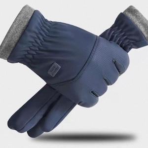 May include: Navy blue gloves with a textured palm and a grey cuff. The gloves are made of a water-resistant material and have a small logo patch. Designed for cold weather, they have a drawstring at the cuff.