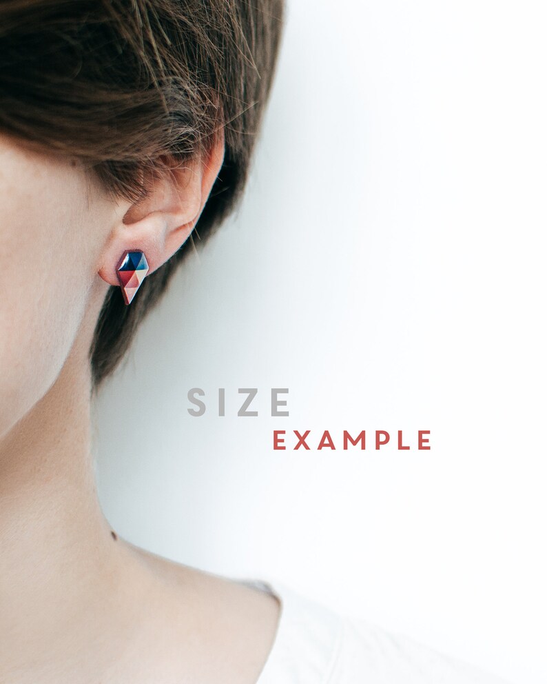 May include: Geometric stud earrings in shades of red, blue, and pink. The earrings have a faceted design and are worn on the ear. The text "SIZE EXAMPLE" is visible in the background.