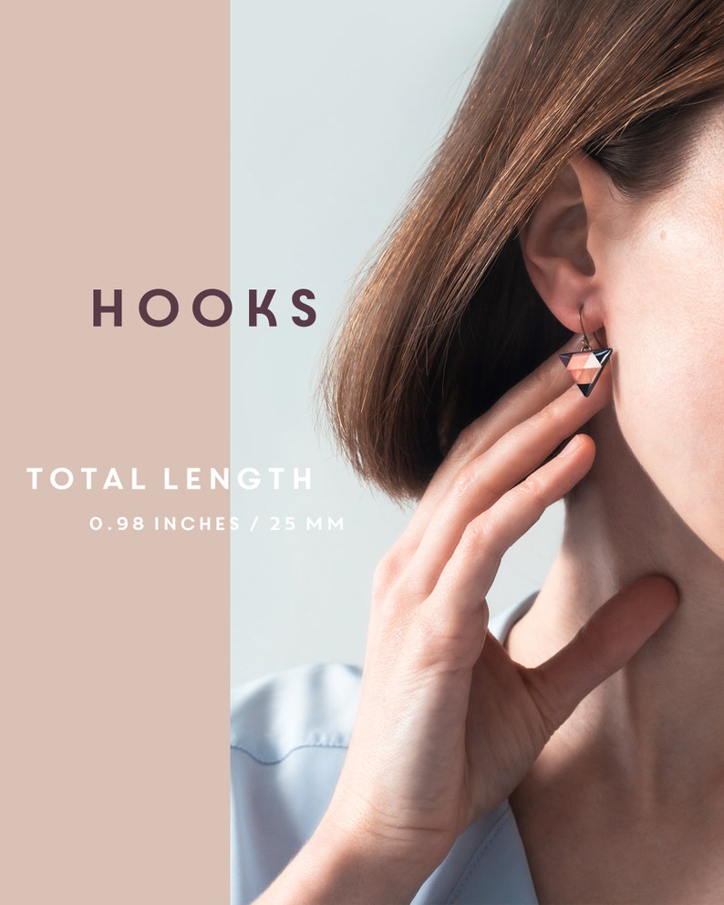 May include: A pair of geometric triangle earrings with a black, white, and pink color scheme. The earrings are made of wood and have a total length of 0.98 inches or 25 mm.