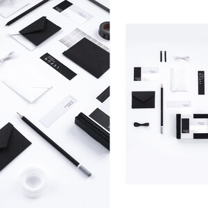 May include: An overhead shot of stationery items in black and white. The items include envelopes, pencils, business cards, a small box, and a roll of tape. The text "LEPUN" and "MINIMALIST JEWELRY" are visible on some of the items.