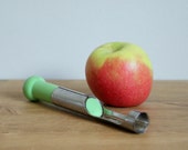 Apple corer, vintage kitchen tools, bright green decor.