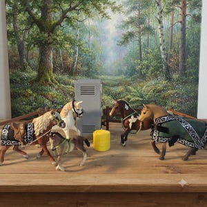 May include: A collection of four plastic horse figurines in a stable setting. The horses feature various coat colors, including brown, white, and tan, and are equipped with detailed saddles, bridles, and blankets. A gray locker and a yellow bale are present.