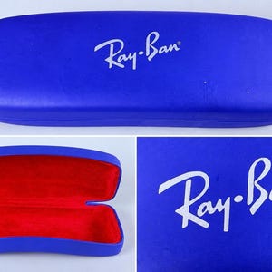 Estuche rígido azul para gafas Ray-Ban con interior rojo y acabado mate tipo concha. imagen 1