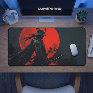 May include: A rectangular black mouse pad featuring a samurai warrior silhouette against a red sun. The mouse pad has the text "LumiPoints" on the top of the image. A white mouse is on the right side of the pad.