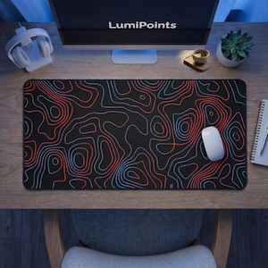 May include: A black rectangular mouse pad with a topographic map design in red and blue lines. A white computer mouse sits on the pad. The text "LumiPoints" is visible on the computer monitor.
