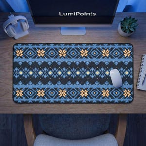 May include: A rectangular desk mouse pad with a black background and a blue and yellow geometric pattern. The mouse pad has the text "LumiPoints" on the computer monitor in the background. A white mouse is on the pad.