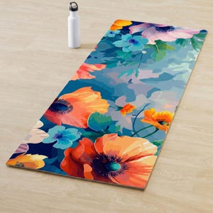 Peut inclure: Un tapis de yoga rectangulaire avec un motif floral vibrant, avec de grands coquelicots orange, des fleurs bleues et roses et des feuilles vertes sur un fond bleu. Une bouteille d'eau blanche est posée sur le sol en bois à côté du tapis.