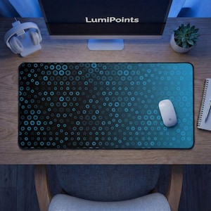 May include: A black and blue mousepad with a pattern of blue circles. The mousepad has a gradient design, transitioning from black to blue. A white computer mouse sits on the mousepad. The word "LumiPoints" is on the computer monitor.
