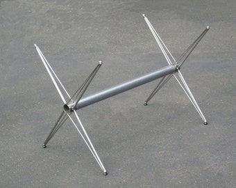 X base, a multipurpose design in stainless steel that is highly adaptable for a variety of table styles