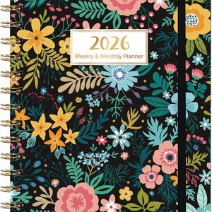 May include: A floral-patterned 2026 weekly and monthly planner. The cover features a black background with a vibrant design of pink, yellow, blue, and green flowers and foliage. The planner has a gold spiral binding and a black elastic band closure.