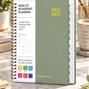 May include: A sage green 2026-27 academic planner with a white vertical band on the left side. The cover features yellow text reading 2026 2027 and a spiral binding. The white section lists features including storage pocket, reference pages, and contacts.