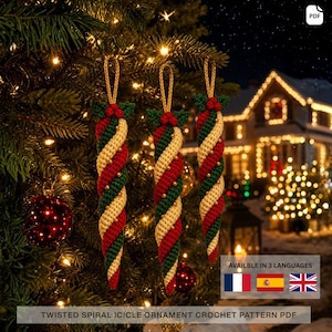 May include: Three hanging icicle ornaments featuring a twisted spiral pattern in alternating red, cream, and dark green yarn. Each ornament is topped with a small cluster of red berries and a gold loop for hanging, showcasing a crochet texture.