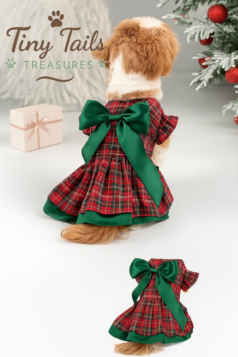May include: A dog wearing a red and green plaid dress with a large green bow on the back. The dress has a layered skirt and green trim. The image includes the text "Tiny Tails Treasures".