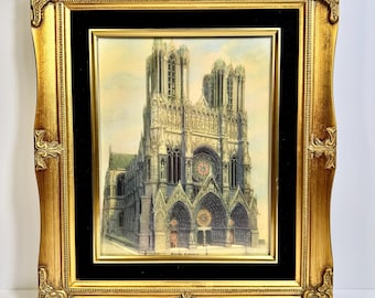 Cromolitografía antigua de la Catedral de Reims, c. 1900, enmarcada, con motivos de arquitectura gótica francesa y marco barroco dorado.