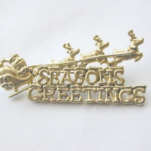 Seasons Greetings Vintage Gold Tone Holiday Christmas Santa Slay and Reindeer Brooch