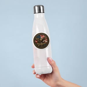 May include: White insulated water bottle with a silver cap. A round sticker on the bottle features an eagle, American flag, and text that reads "United States Armed Forces" and "250 Years United in Service."