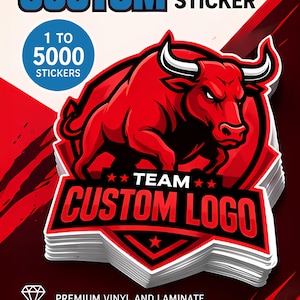 May include: A stack of custom die cut stickers featuring a red bull illustration with white horns, black outlines, and the text TEAM CUSTOM LOGO. The design includes a blue circle with 1 TO 5000 STICKERS, plus text stating PREMIUM VINYL AND LAMINATE.