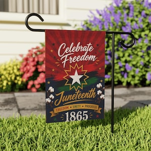 May include: A Juneteenth garden flag with the words "Celebrate Freedom" in white script over a red and black background. The flag features a star, the word "Juneteenth", and the year 1865.