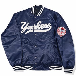 May include: A set of three ceramic vases in varying heights and shapes. The vases are glazed in a matte white finish, offering a minimalist aesthetic. The tallest vase measures approximately 10 inches high.