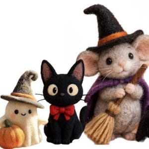 May include: Three needle-felted figures: a white ghost wearing a gray witch hat and holding an orange pumpkin, a black cat with a red bow tie, and a gray mouse wearing a black witch hat with an orange band and a purple cape holding a broom.