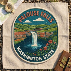 May include: A circular embroidered patch featuring a landscape of Palouse Falls in Washington State. The design includes a waterfall, orange cliffs, green hills, and orange flowers against a teal sky with white clouds and bold text.