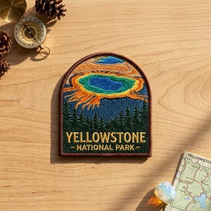 May include: An embroidered patch with an arched top featuring a colorful landscape of Yellowstone National Park. The design includes a blue and orange thermal spring above a dark green forest, with the text YELLOWSTONE NATIONAL PARK below.