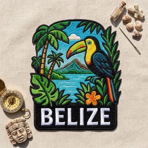 May include: An embroidered patch featuring a toucan with a yellow, green, and orange beak, perched near palm trees, a mountain, and water. The word BELIZE is stitched in white capital letters on a black background at the bottom of the patch.