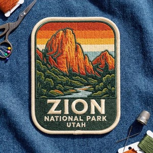 May include: A rectangular embroidered patch featuring a landscape of Zion National Park with orange cliffs, green trees, and a river under a sunset sky. The text ZION NATIONAL PARK UTAH is stitched in cream thread on a dark green background.