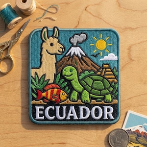 May include: A square embroidered patch featuring a beige llama, a green turtle, and a red and yellow striped fish. The background shows a brown volcano with smoke, a yellow sun, and a blue sky. The word ECUADOR is stitched in white at the bottom.