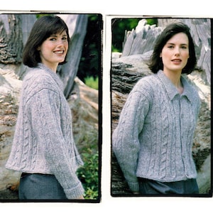 May include: Two women wearing gray cable knit cardigans with button closures. The cardigans have a relaxed fit and are styled with a casual look.