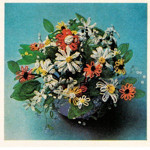 May include: A bouquet of beaded flowers in a blue vase. The flowers are white, red, and yellow, and they are arranged in a circular pattern. The flowers are made of small beads, and they are very realistic.