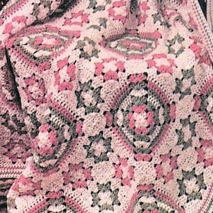 May include: Crochet pattern to make a Blossom & Bud Afghan. The pattern features a pink, green, and white crochet blanket with a geometric design.