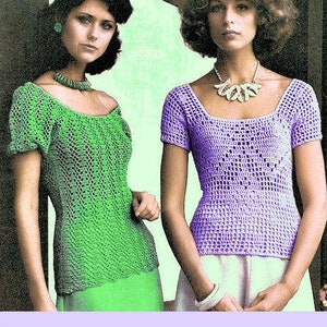 May include: Two women wearing crocheted tops. The woman on the left is wearing a green top with a scoop neck and short sleeves. The woman on the right is wearing a lavender top with a scoop neck and short sleeves.