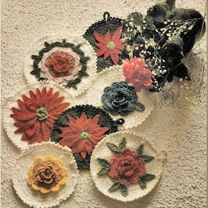 May include: Crochet pattern to make Rose & Poinsettia Pot Holders. The image shows eight crocheted pot holders with floral designs in red, green, yellow, and blue.