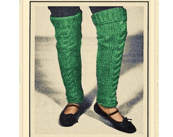 May include: Knitting pattern to make cable leg warmers. The image shows a pair of green cable knit leg warmers being worn by a person.