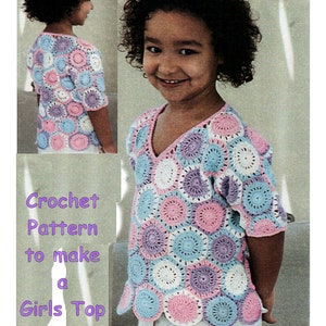 May include: Crochet pattern to make a girls top. The top is made with a variety of colors, including pink, blue, and purple. The top has a V-neck and short sleeves.