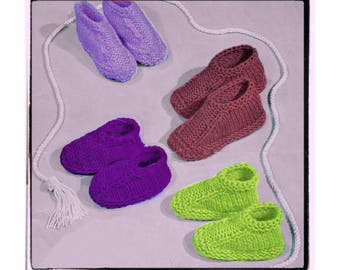 May include: Six pairs of knitted slippers in various colors, including purple, green, and brown. The slippers are laid out on a light gray surface.