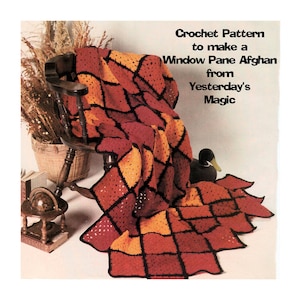 May include: Crochet pattern to make a Window Pane Afghan from Yesterday's Magic. The afghan is red, orange, and black and is draped over a wooden chair.