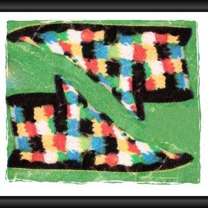 May include: Two colorful slippers with a checkered pattern in black, white, red, yellow, and blue. The slippers are on a green background.