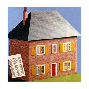May include: A red brick dollhouse with a gray shingled roof. The house has five windows with yellow shutters and heart-shaped cutouts. The front door is red. The text on the paper reads: "We used a delightful range of specialty paper to paper our rooms. Try using thin wrap paper to paper while of your own sweet time with a small scale pattern."